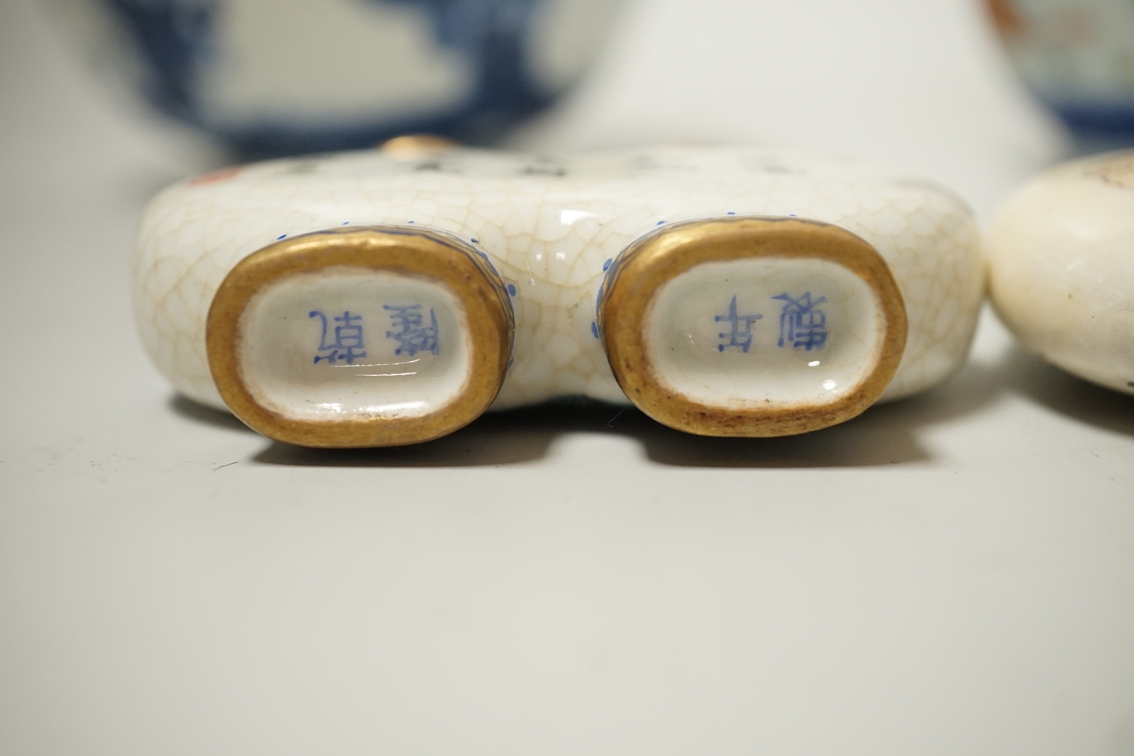 A 19th century Chinese blue and white bowl, an enamelled goldfish cup and two snuff bottles